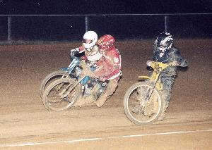 Alex Heath (r.) slides low while Dave Clark (c.) and 